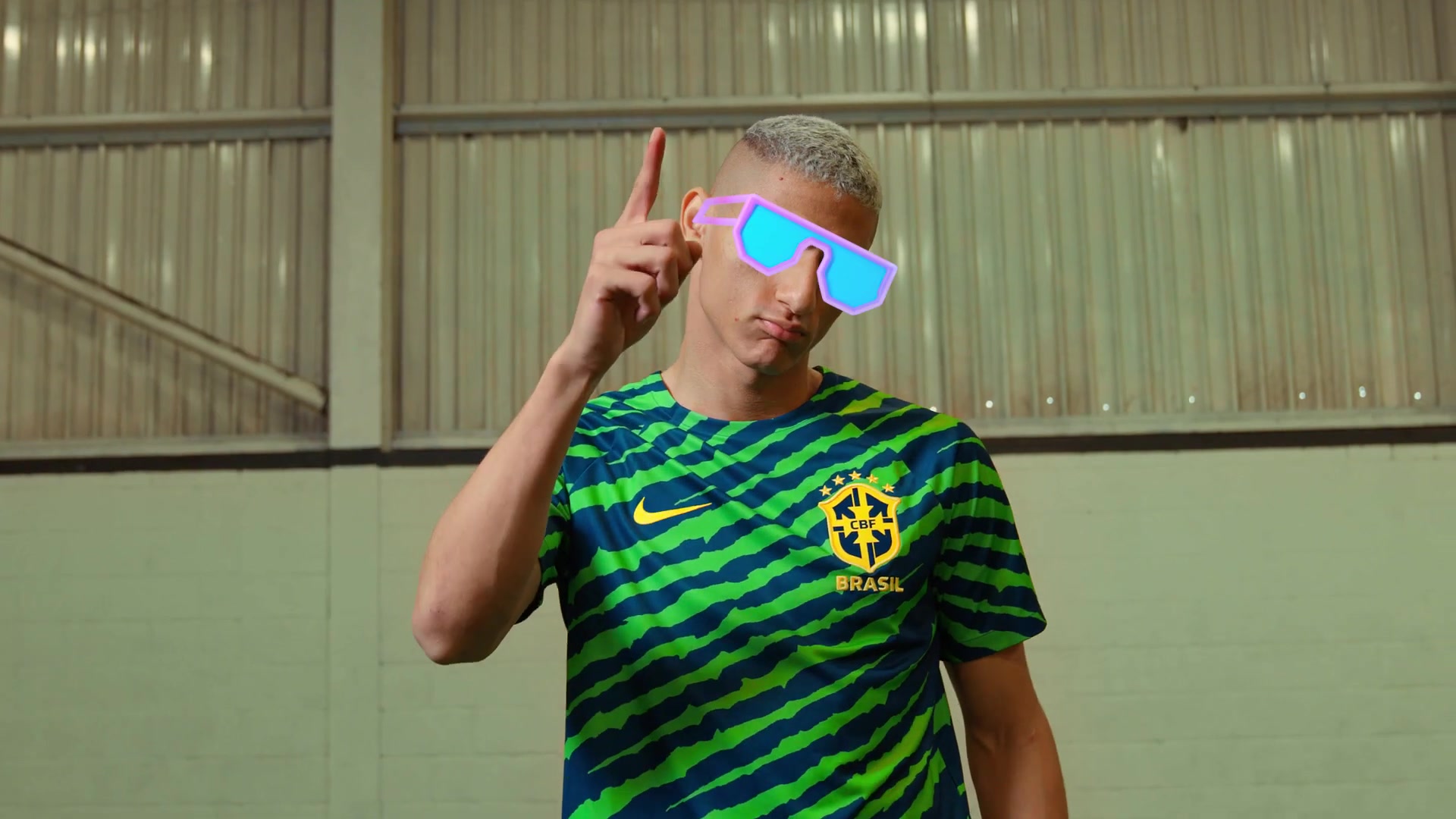 Richarlison in a Brazil training top and neon sunglasses